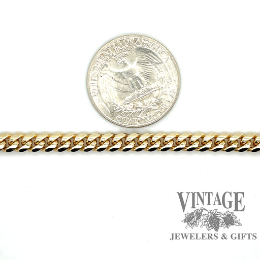 14 karat yellow gold 7.5” 6mm solid curb link bracelet, shown with quarter for size reference