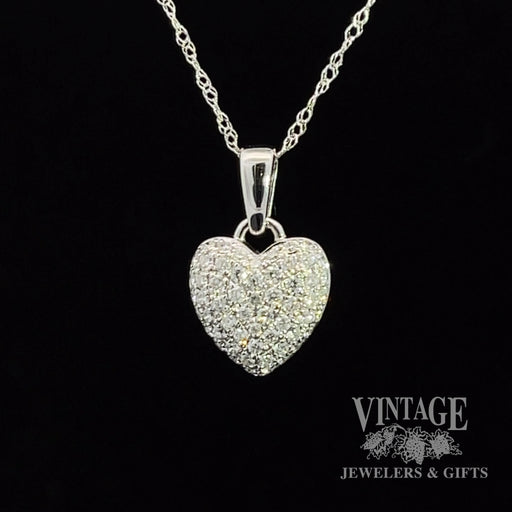 14 karat white gold diamond pave heart pendant. 57 round brilliant, colorless, VS clarity, natural diamonds totaling .33 carats. Includes a 14 karat white gold, 18” length, 1.0 mm loose rope cha