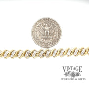 Twisting diamond tennis 14ky gold bracelet scale