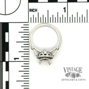 Diamond and caliber cut sapphire halo platinum ring scale