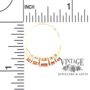 10 karat yellow gold 5-stone mandarin garnet ring, with scale