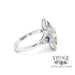 Elongated oval diamond and caliber cut sappire 14kw gold ring side