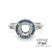 Diamond and caliber cut sapphire halo platinum ring