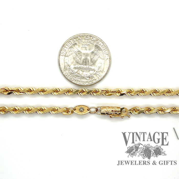 14 karat yellow gold 18” 3.1 mm diamond cut rope chain, shown with quarter for size reference
