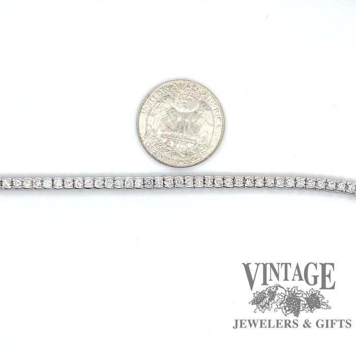 14 karat white gold 3.25 ct. total weight 7” natural diamond line bracelet, shown with quarter for size reference
