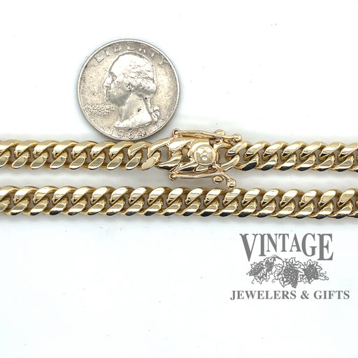 26” 10 karat yellow solid gold 7 mm Cuban link chain necklace, shown with quarter for size reference