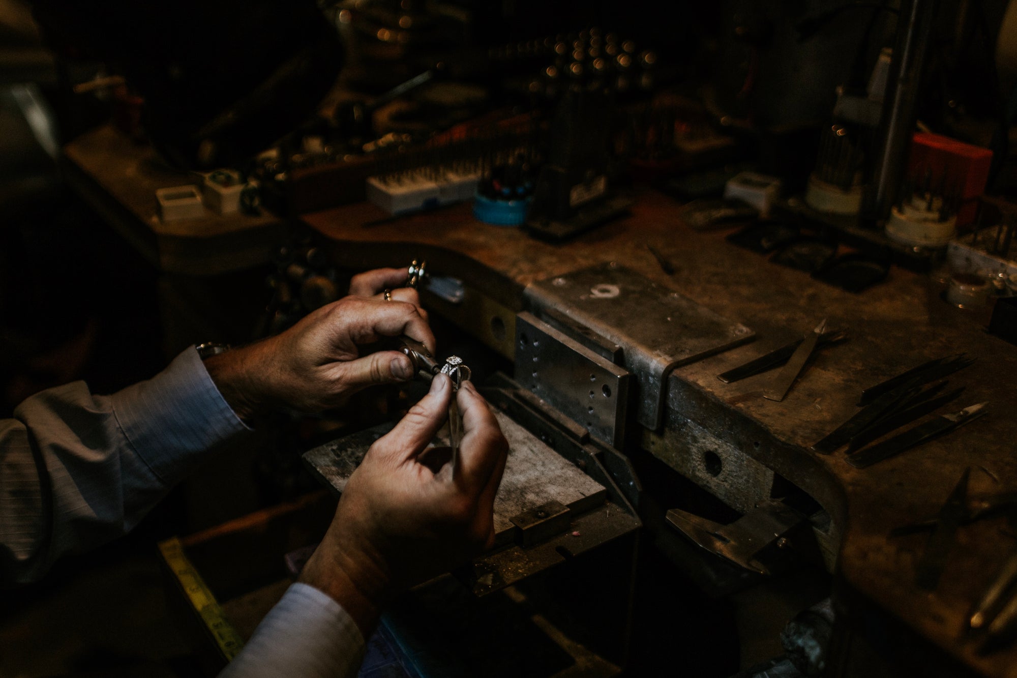 Goldsmiths soldering a ring at their Jewelers bench in Windsor, California