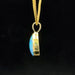 Ethiopian opal set in yellow gold teardrop pendant side