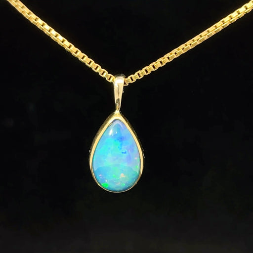 Ethiopian opal set in yellow gold teardrop pendant