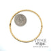 Twisted stripe 14k yellow gold bangle bracelet scale