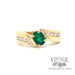 Emerald and diamond accents set in 18k yellow gold bypass ring