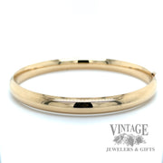 Polished 14k gold hinged bangle bracelet