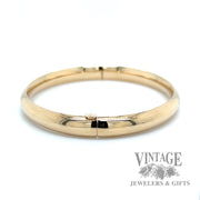 Polished 14k gold hinged bangle bracelet side