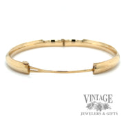 Polished 14k gold hinged bangle bracelet open side