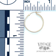 Huggie 14k yellow earrings scale