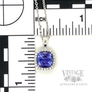 Cushion shaped tanzanite and diamond 14k white gold halo pendant