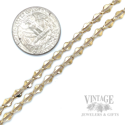 Decorative scalloped bar links create a repeating dimensional pattern with a polished finish throughout the necklace
