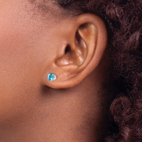 14 karat white gold Blue Topaz 5mm stud earrings, shown on model