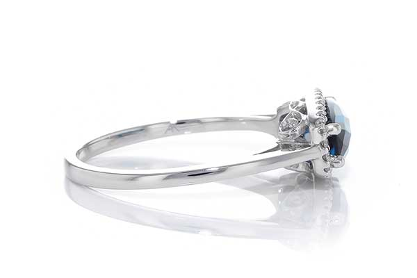 14kw gold East-West London blue topaz and diamond halo ring, side view
