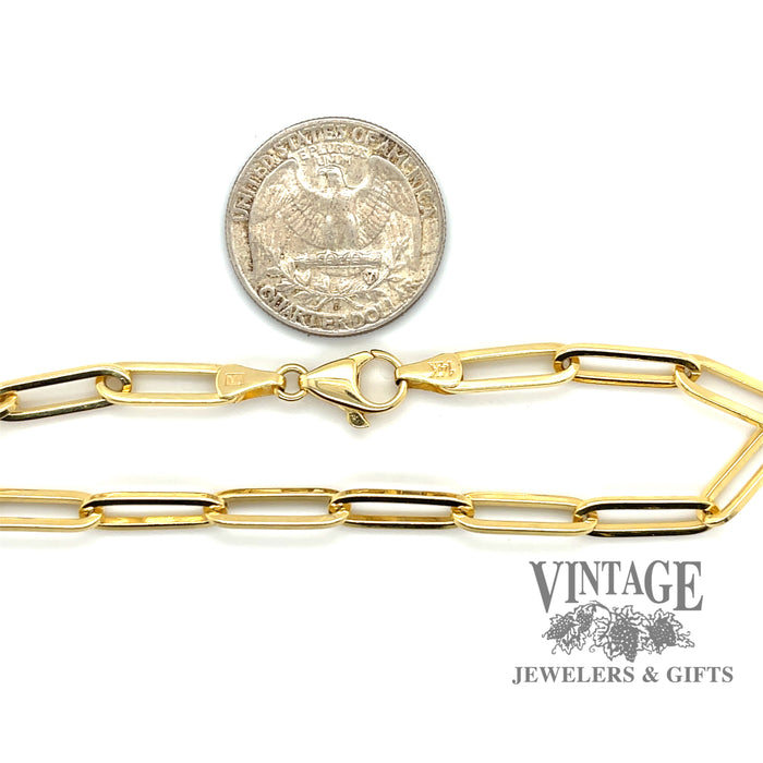 8.25” 14 karat yellow gold solid link Paperclip Bracelet, shown with quarter for size reference