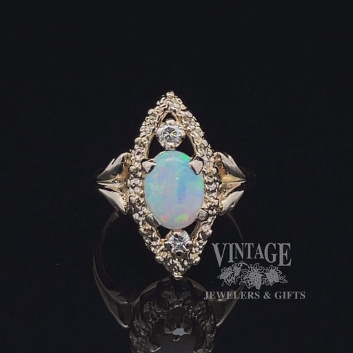 Revolving video of 14 karat yellow gold natural opal and diamond navette ring