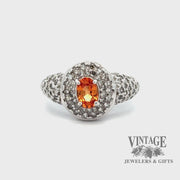 Revolving video of 10kw gold oval spessartine diamond pave ring