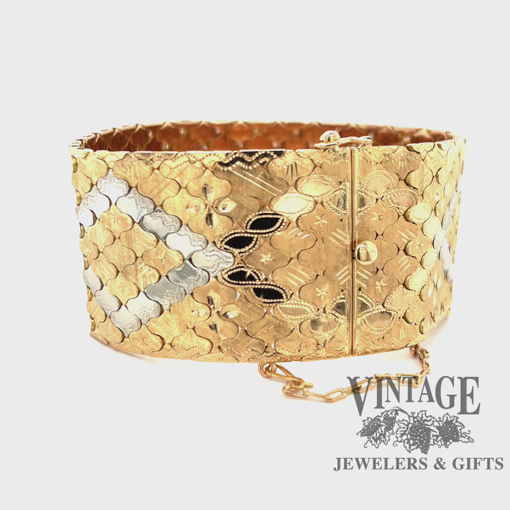 Revolving video of 18 karat yellow gold hand engraved, solid, wide, two tone bracelet