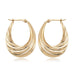 14 karat yellow gold swirl design medium oval crescent hoop earrings