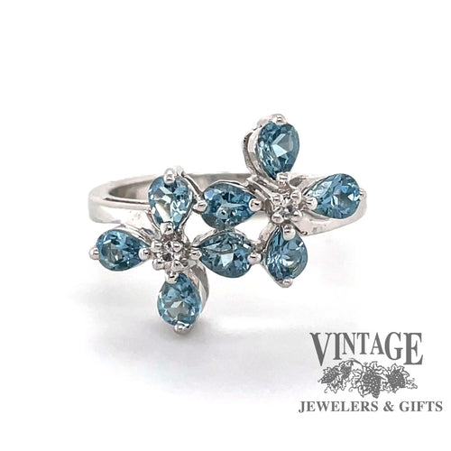 Revolving video of 14 karat white gold pear shaped aquamarine flower ring