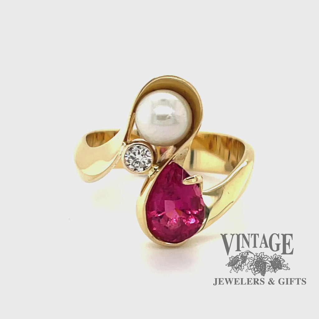 Revolving video of 18 karat yellow gold pink tourmaline pearl and diamond bypass ring