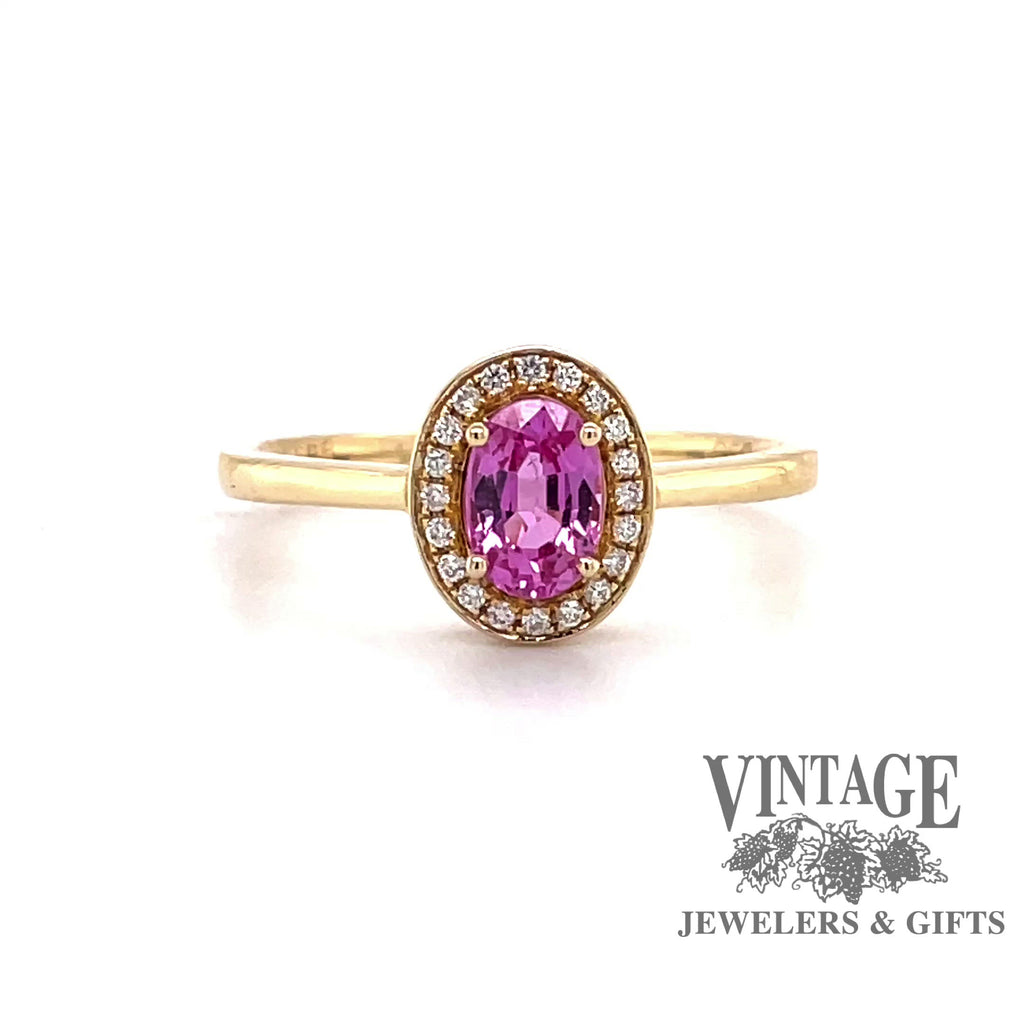 Revolving video of 14 karat yellow gold oval pink sapphire and diamond halo ring