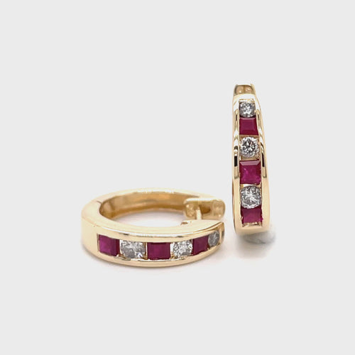 Revolving video of 14 karat yellow gold Ruby and diamond huggie hoop earrings