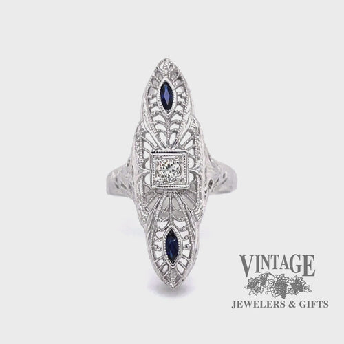 Revolving video of 18 karat white gold vintage filigree elongated sapphire and diamond ring