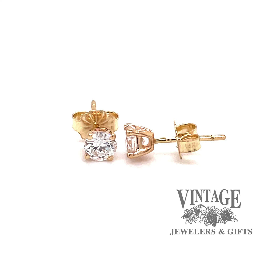 Revolving video of 14 karat yellow gold .66 carats total weight diamond stud earrings
