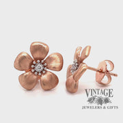 Revolving video of 14 karat rose gold floral  diamond earrings