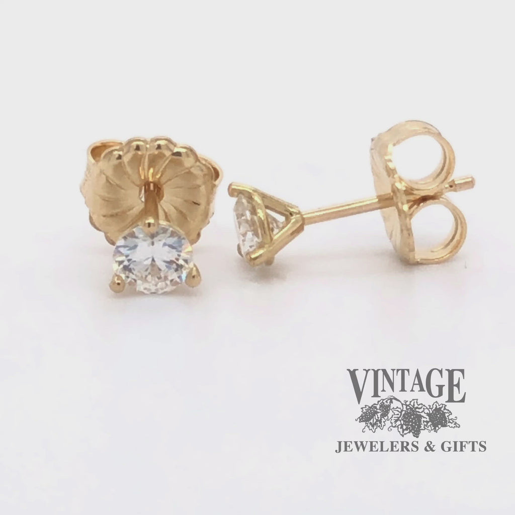 Revolving 360 degree video of .50ct total weight 18k gold diamond stud earrings in martini setting.