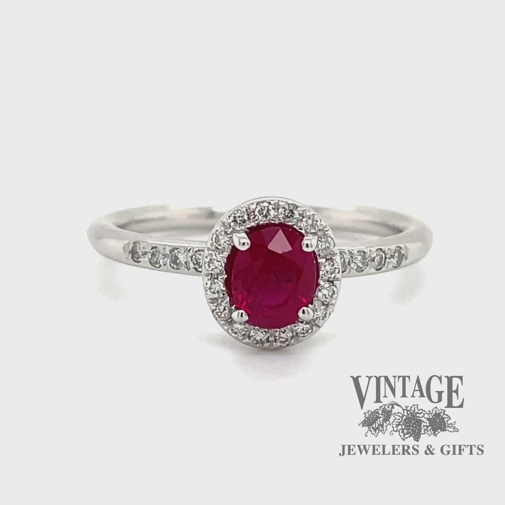 Revolving video of 14 karat white gold oval ruby  and diamond halo ring