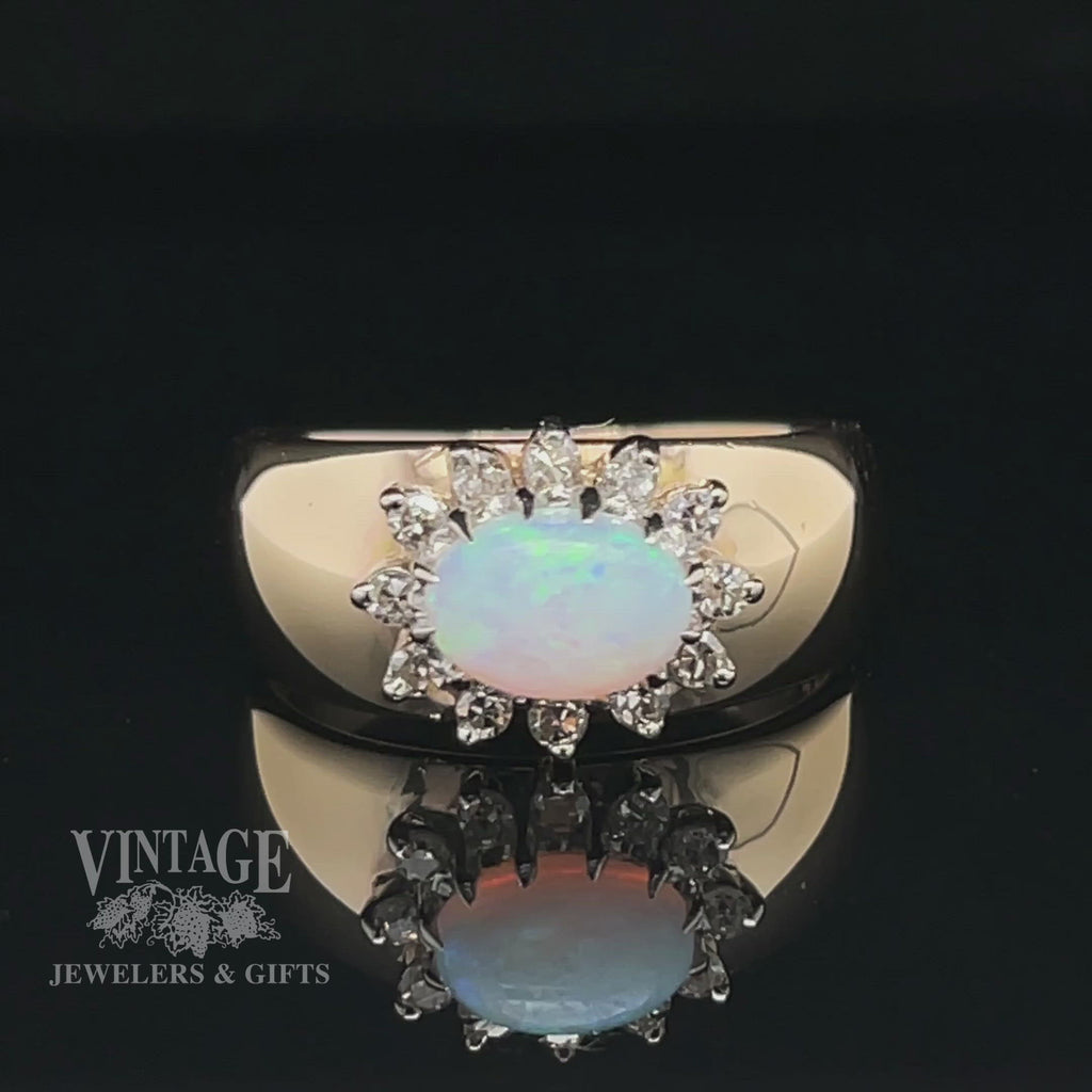 Revolving video of 14 karat yellow gold opal and diamond sideways halo ring. Note: There are no hearts or black areas on the band of the ring. It is camera reflection