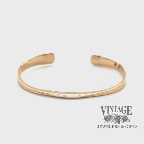 Revolving video of 14 karat yellow gold forged Anticlastic cuff bangle bracelet