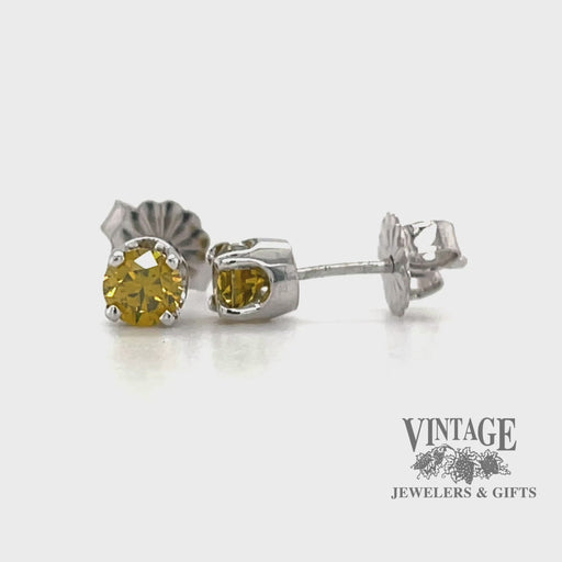 Revolving video of 14 karat white gold .52 carat total weight canary diamond stud earrings