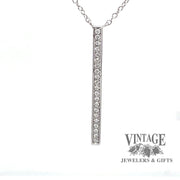 Revolving video of  14 karat white gold diamond bar pendant