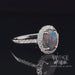 Revolving video of 14 karat white gold 1.28ct natural black opal and diamond halo ring