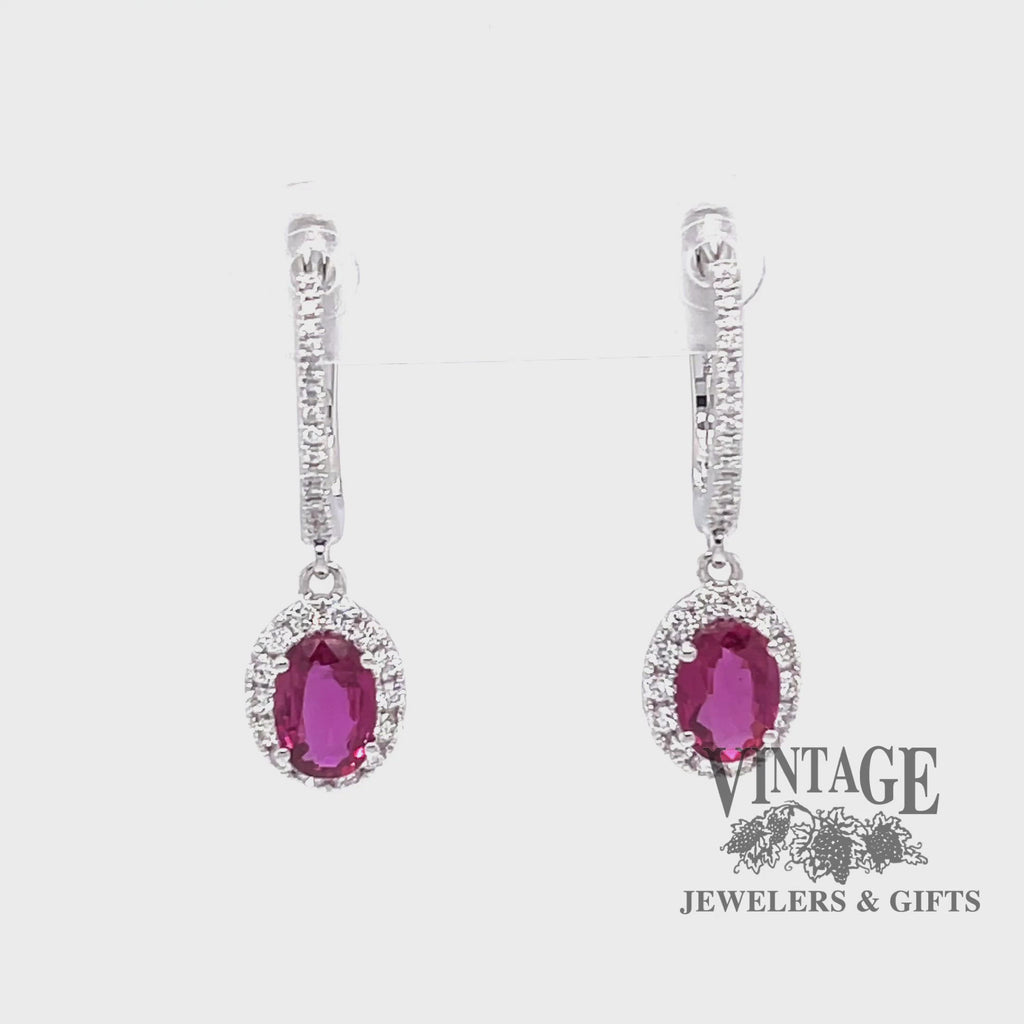 Revolving video of 14 karat white gold oval ruby and diamond halo drop earrings