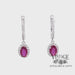 Revolving video of 14 karat white gold oval ruby and diamond halo drop earrings