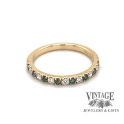 Revolving video of 14 karat yellow gold band with alternating round brilliant diamonds and emeralds