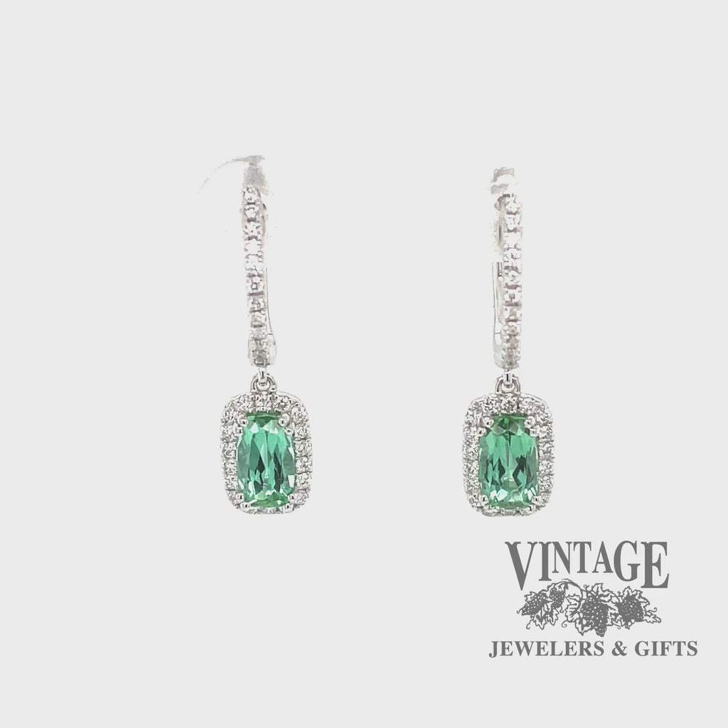 Revolving video of 14 karat white gold diamond huggie drop earrings with stunning teal colored tourmalines
