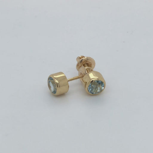 Revolving video of 14 karat yellow gold bezel set aquamarine stud earrings with screw post and nut.