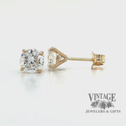 Revolving video of 14 karat yellow gold 1.5 carat total weight lab grown round diamond pierced stud earrings