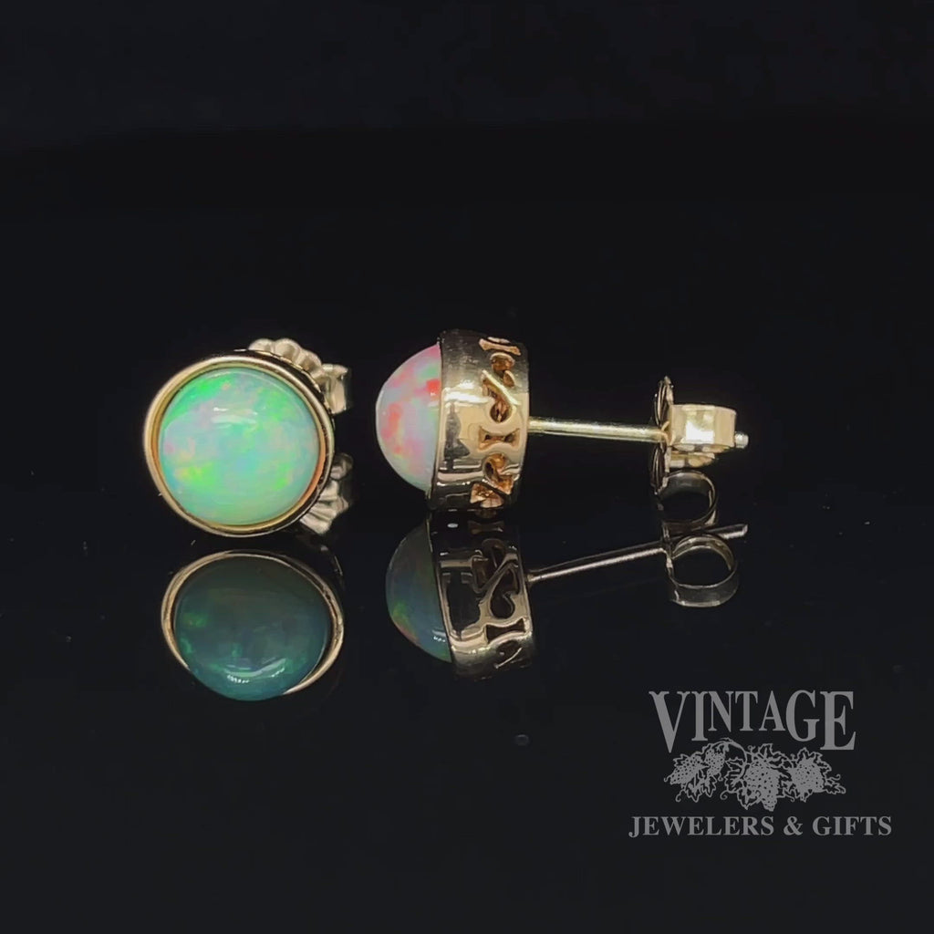 Revolving video of 14 karat yellow gold 7mm round Ethiopian opal pierced stud earrings