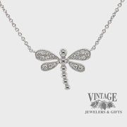 Revolving video of 14 karat white gold .14 carats total weight diamond dragonfly necklace